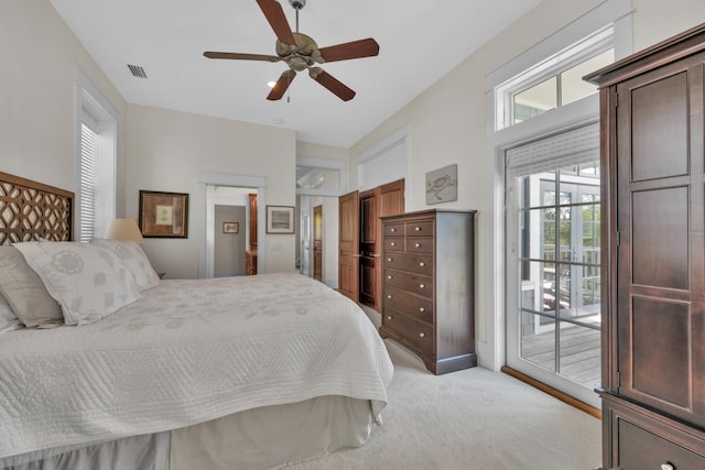 bedroom with light colored carpet, multiple windows, ceiling fan, and access to outside