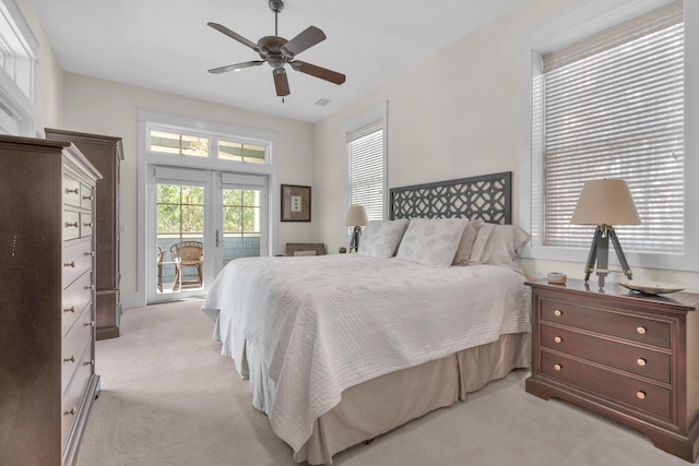 bedroom with ceiling fan, light carpet, and access to outside