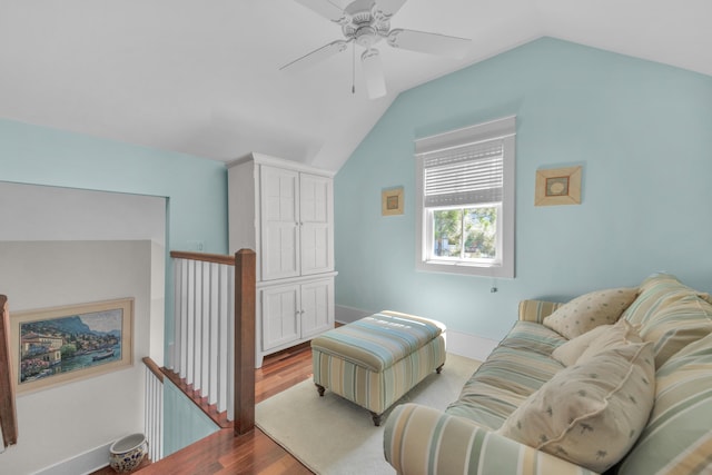 living room featuring wood-type flooring, ceiling fan, and vaulted ceiling