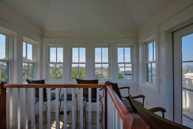 sunroom featuring vaulted ceiling