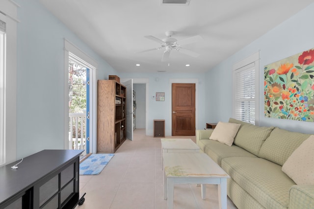 tiled living room with ceiling fan