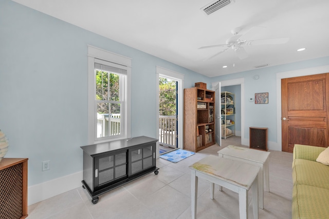 living room featuring ceiling fan and light tile floors