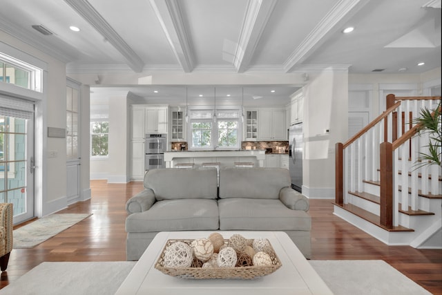 living room with a healthy amount of sunlight, wood-type flooring, and crown molding