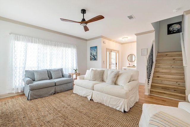 living room with ceiling fan, light hardwood / wood-style floors, and crown molding