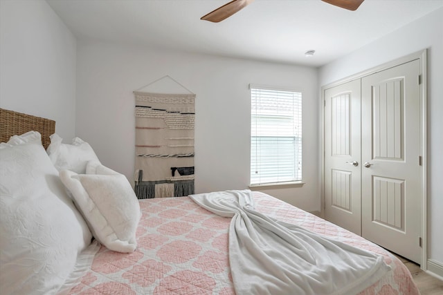 bedroom featuring a closet, multiple windows, and ceiling fan