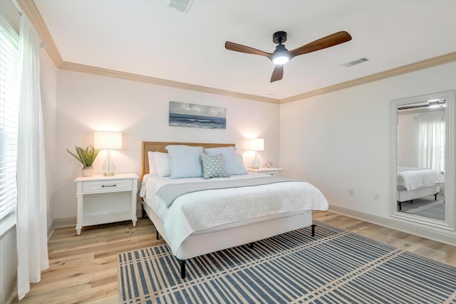 bedroom featuring ornamental molding, light hardwood / wood-style flooring, and ceiling fan