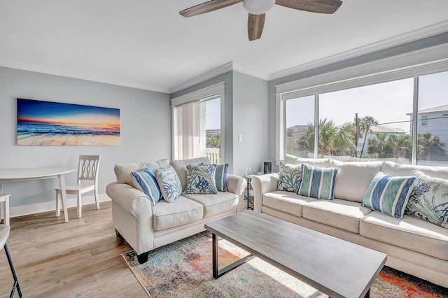 living room featuring ceiling fan, light hardwood / wood-style floors, and ornamental molding