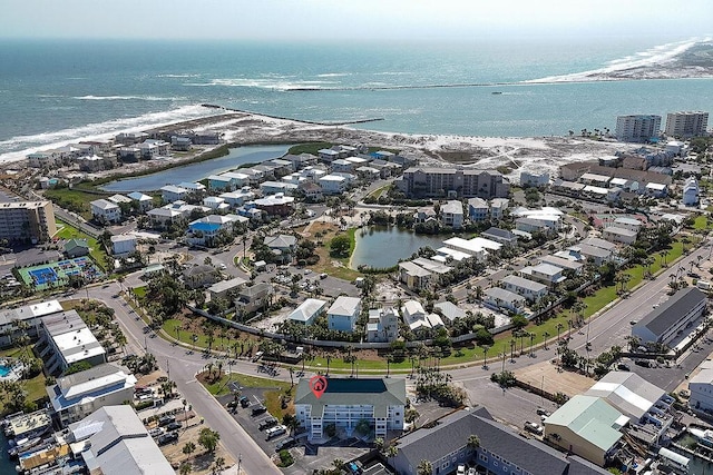 drone / aerial view featuring a water view and a view of the beach