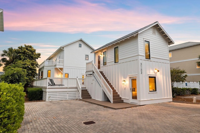 view of front facade with stairway and board and batten siding