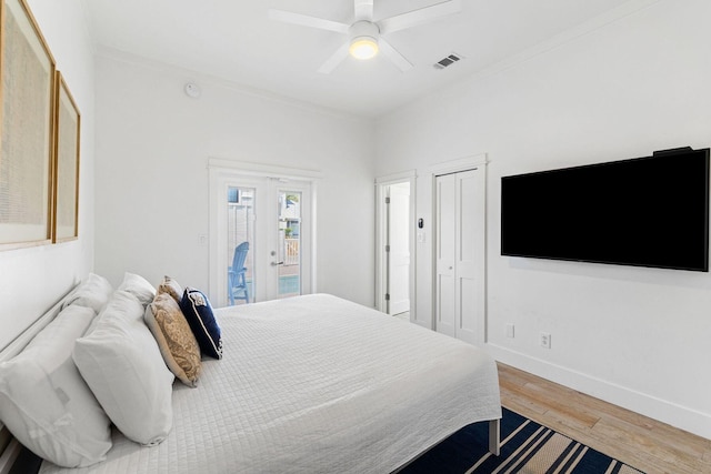 bedroom with visible vents, baseboards, light wood-style flooring, ornamental molding, and access to exterior