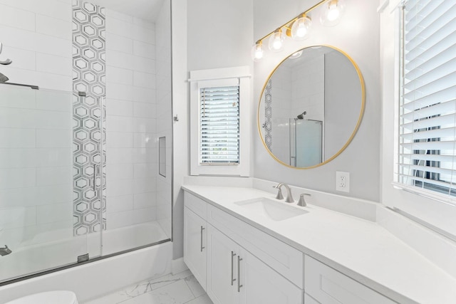 full bath featuring enclosed tub / shower combo, marble finish floor, and vanity