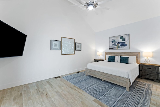 bedroom featuring ceiling fan, high vaulted ceiling, wood finished floors, visible vents, and baseboards