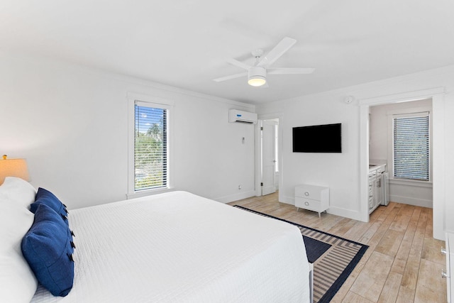 bedroom featuring a ceiling fan, a wall mounted air conditioner, light wood-style flooring, and baseboards