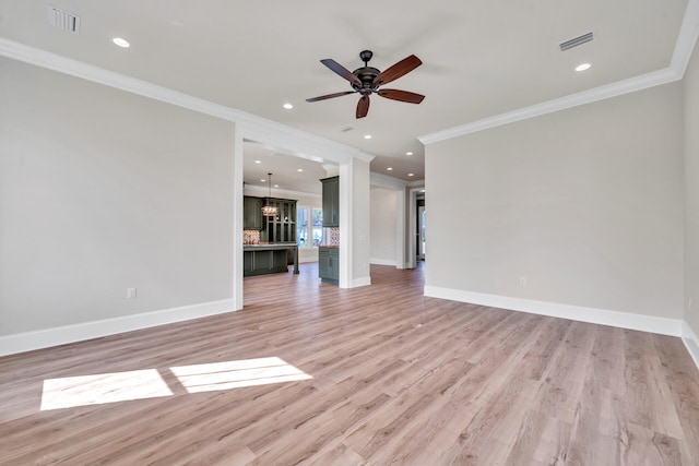 unfurnished living room with ceiling fan, light hardwood / wood-style floors, and crown molding