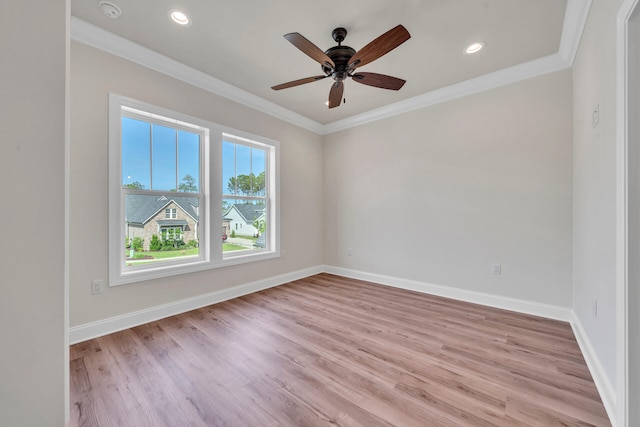 spare room with crown molding, ceiling fan, and light wood-type flooring