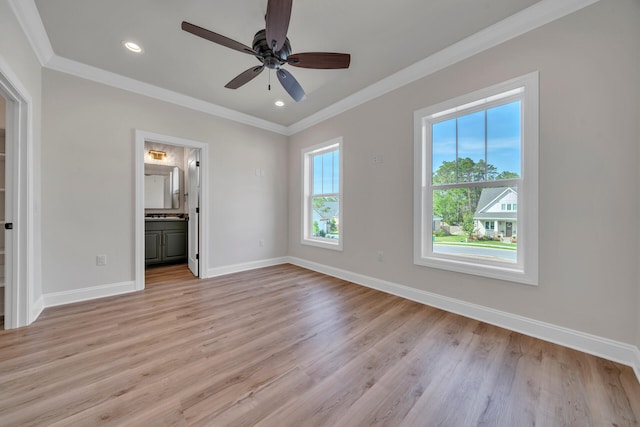 unfurnished bedroom with light wood-type flooring, ensuite bathroom, multiple windows, and ceiling fan