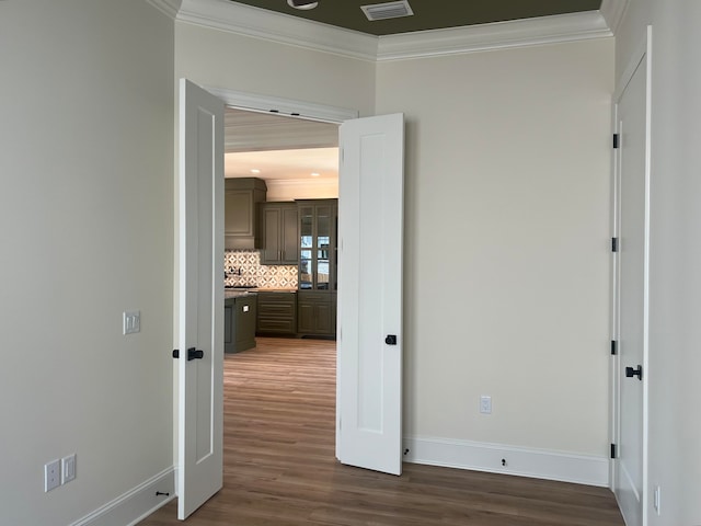 corridor featuring crown molding and dark wood-type flooring