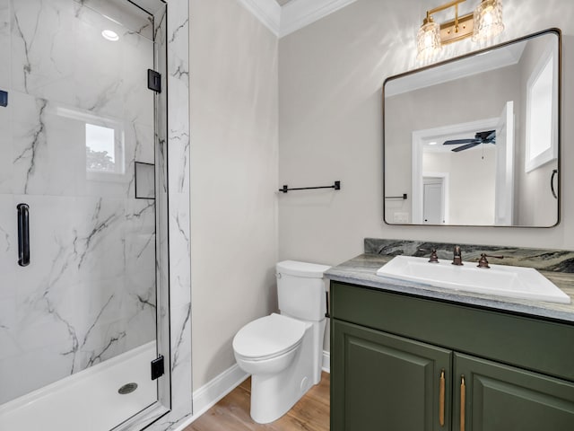 bathroom featuring ceiling fan, toilet, hardwood / wood-style flooring, a shower with door, and ornamental molding