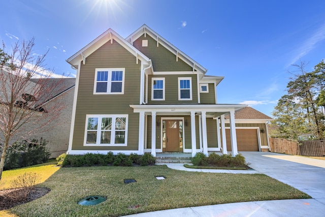 view of front facade featuring driveway, a porch, a front lawn, and an attached garage