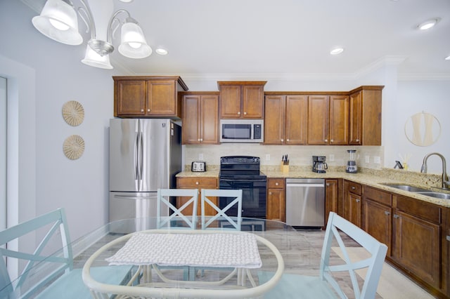 kitchen with light stone countertops, crown molding, backsplash, stainless steel appliances, and sink