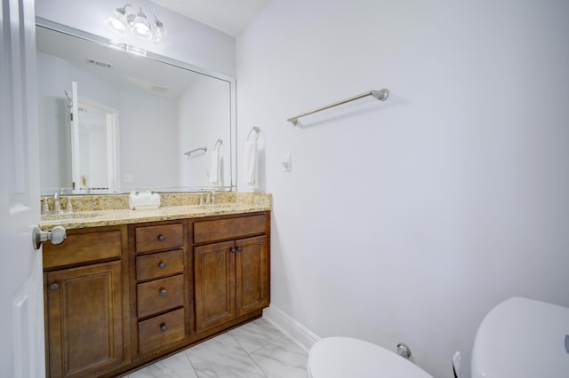 bathroom featuring dual bowl vanity, toilet, and tile flooring