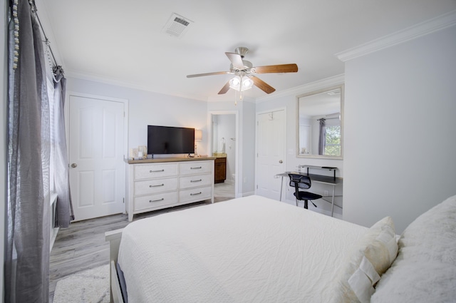 bedroom with crown molding, light hardwood / wood-style flooring, connected bathroom, and ceiling fan