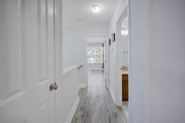 hallway with light hardwood / wood-style flooring