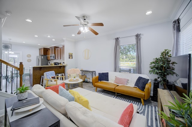 living room featuring ornamental molding, hardwood / wood-style floors, and ceiling fan