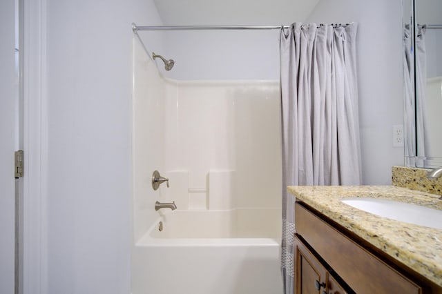 bathroom featuring shower / bath combo and vanity