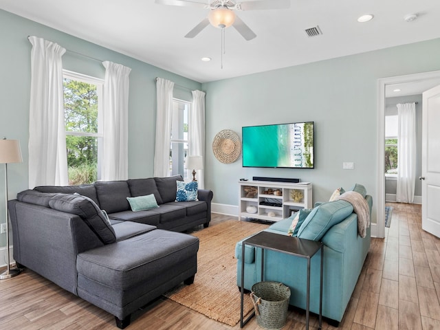 living room featuring ceiling fan and hardwood / wood-style flooring