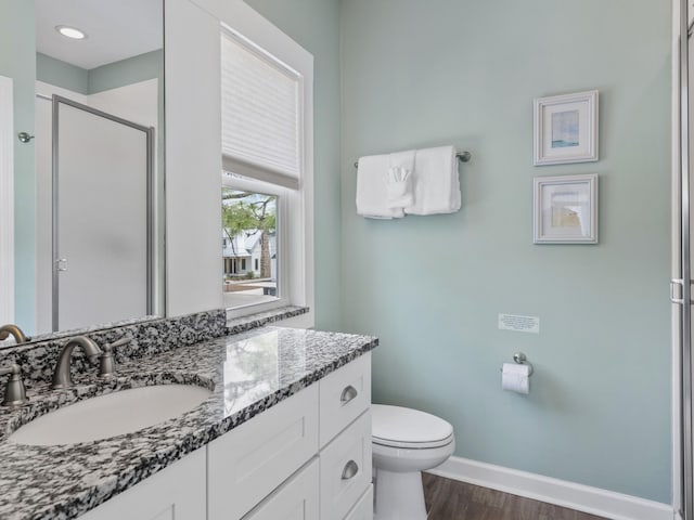 bathroom with toilet, oversized vanity, and hardwood / wood-style floors