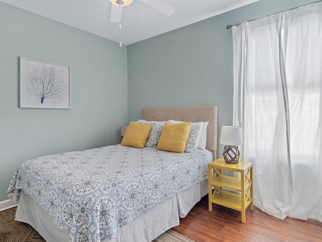 bedroom with wood-type flooring and ceiling fan