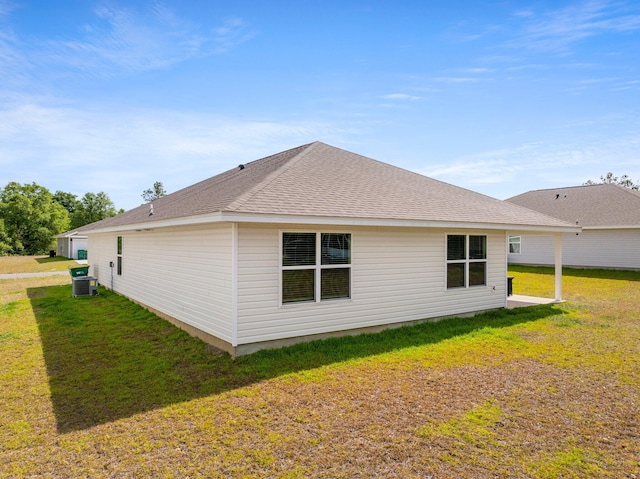 back of property featuring a yard