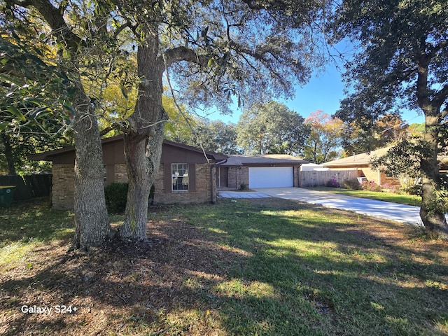 single story home featuring a garage and a front lawn