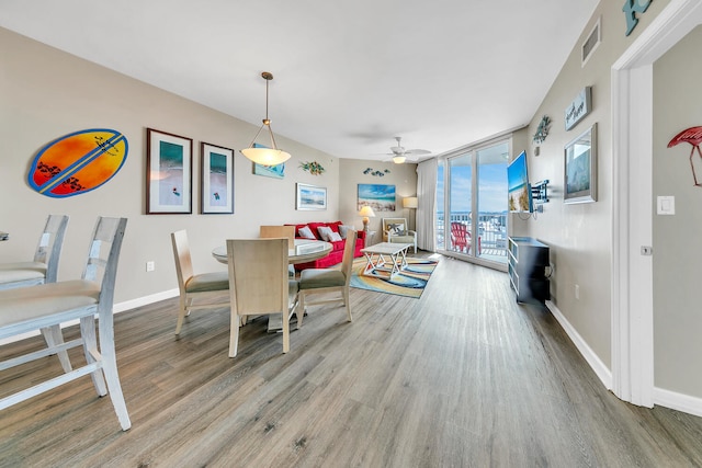 dining space with wood-type flooring and ceiling fan