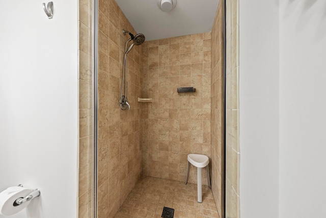 bathroom with a shower with door