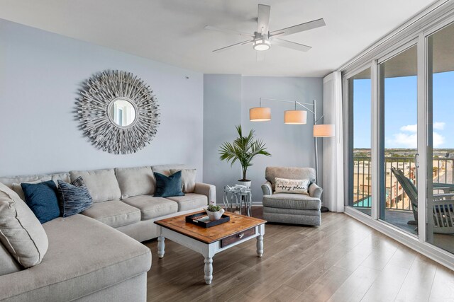 living room featuring ceiling fan and hardwood / wood-style flooring