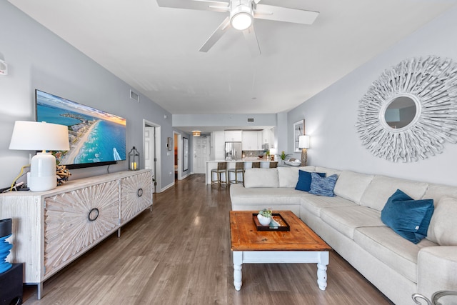 living room with wood-type flooring and ceiling fan