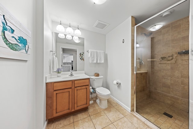 bathroom with walk in shower, large vanity, tile floors, and toilet