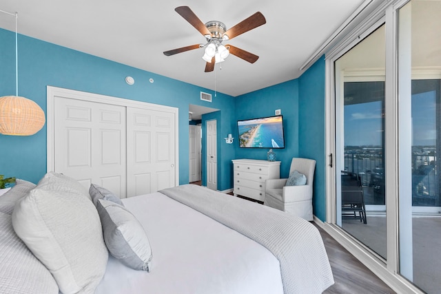 bedroom featuring access to outside, wood-type flooring, ceiling fan, and a closet