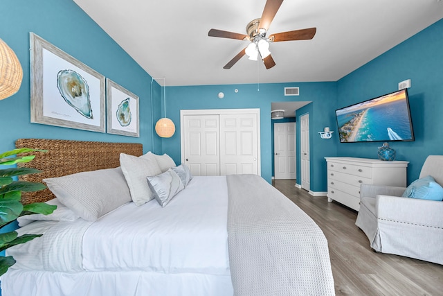 bedroom featuring hardwood / wood-style floors, a closet, and ceiling fan