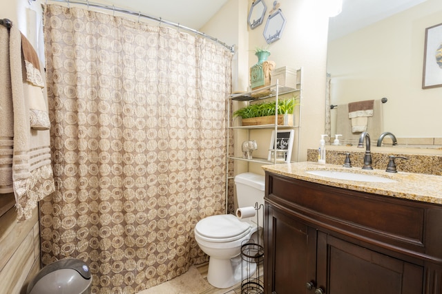 bathroom with vanity, toilet, and curtained shower