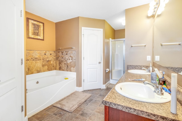 full bathroom featuring double vanity, a sink, a garden tub, and a stall shower