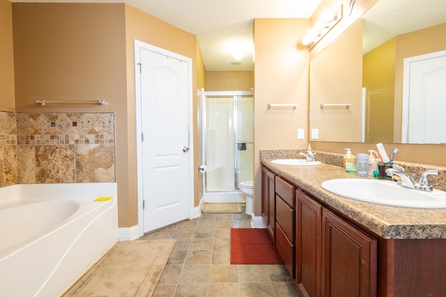 full bath featuring double vanity, a sink, baseboards, and a stall shower