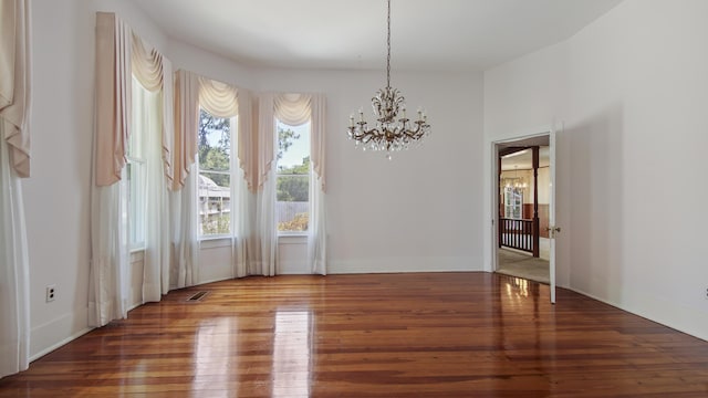 dining area featuring an inviting chandelier and hardwood / wood-style flooring