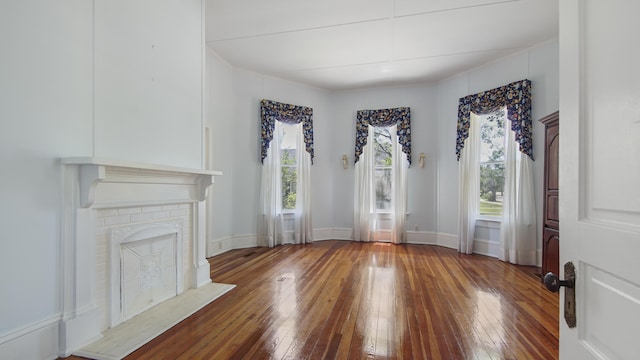 living room with dark hardwood / wood-style floors and a brick fireplace