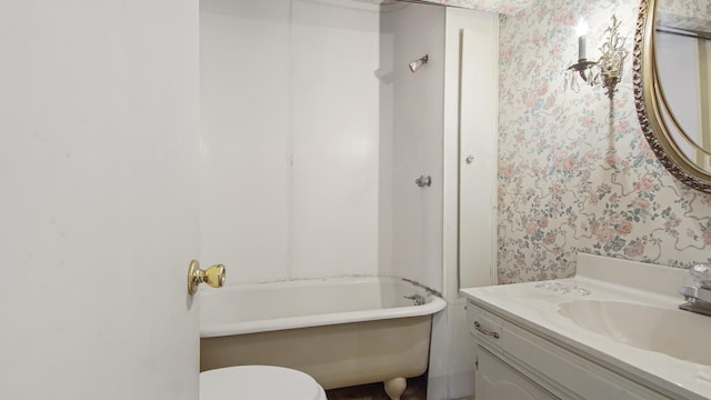 bathroom featuring vanity, toilet, and a bathing tub