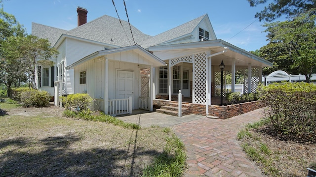 back of property featuring a porch