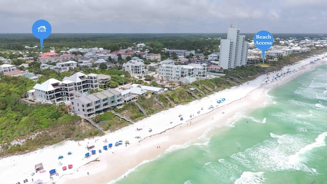 birds eye view of property with a view of the beach and a water view