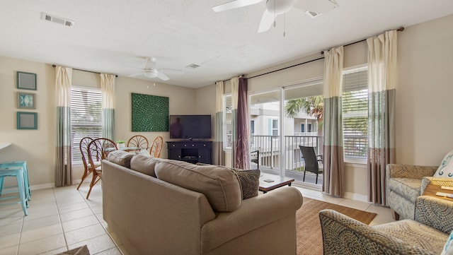 tiled living room featuring ceiling fan